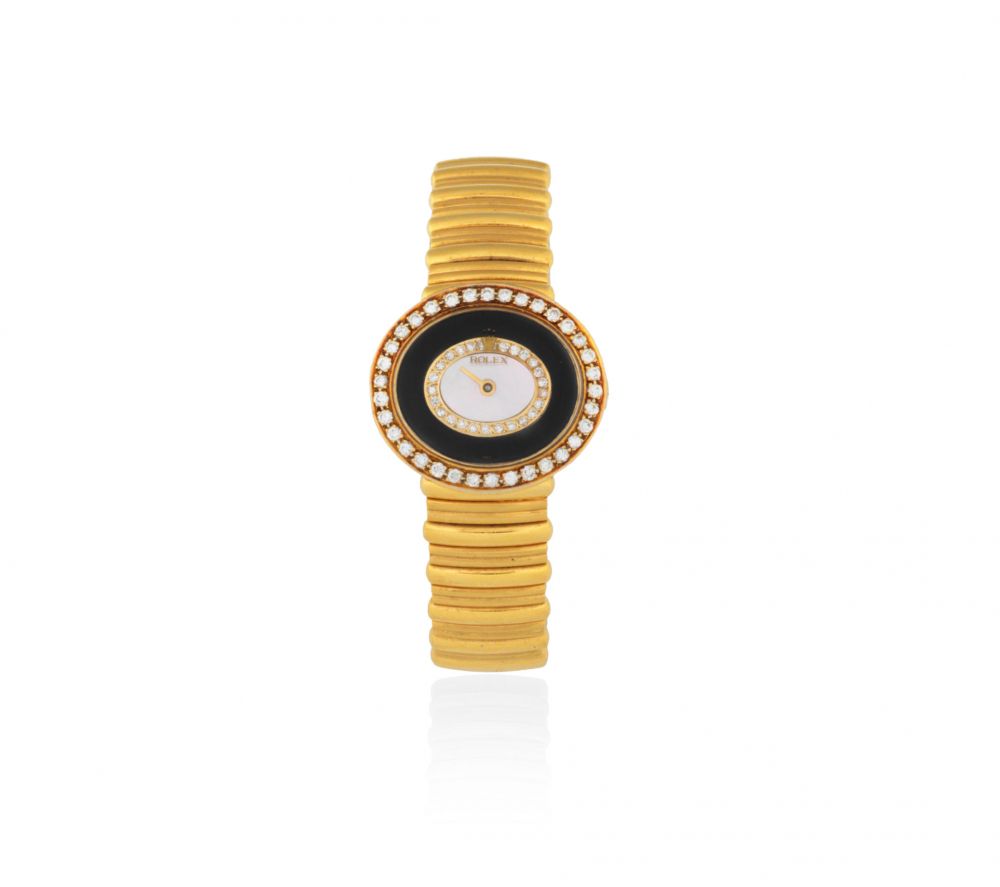 Rolex. A lady's 18K gold diamond set manual wind bracelet watch