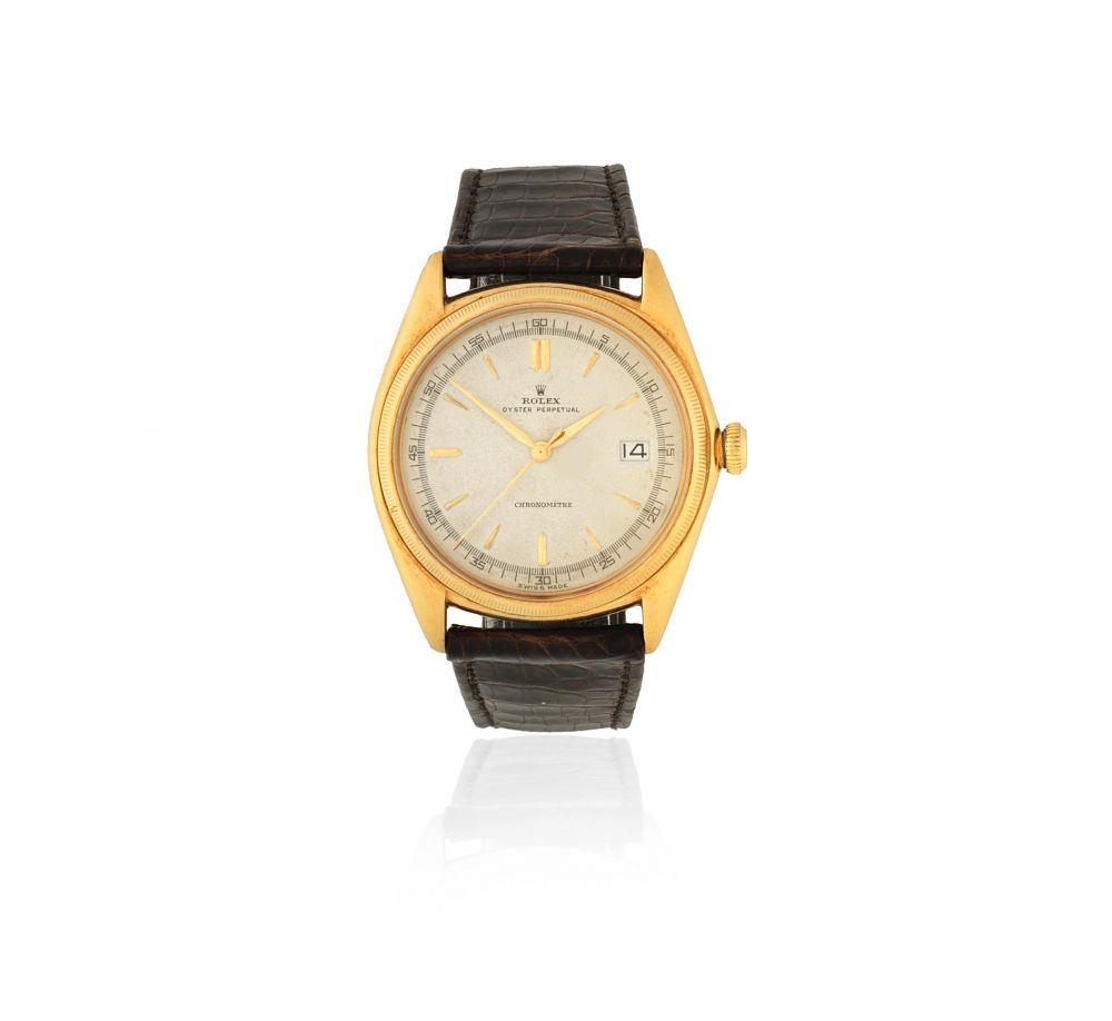 Rolex. An 18K gold automatic calendar bubble back wristwatch