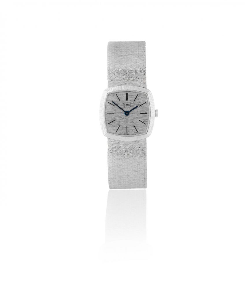Piaget. A lady's 18K white gold manual wind cushion form bracelet watch
