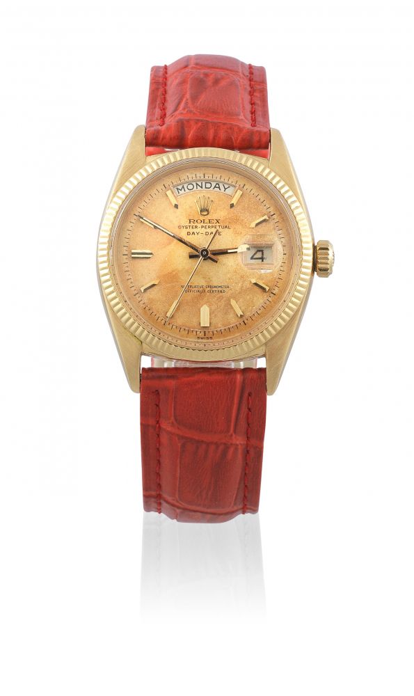 Rolex. An 18K gold automatic calendar wristwatch