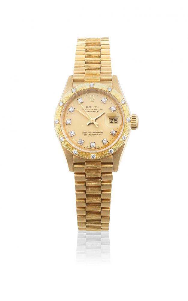 Rolex. A lady's 18K gold and diamond set automatic calendar bracelet watch