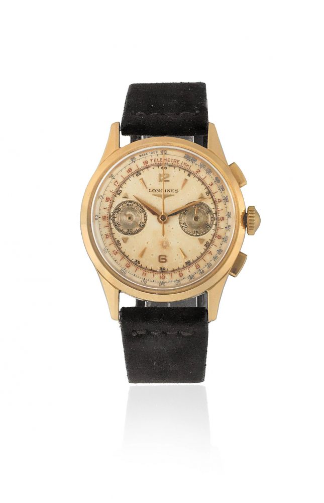 Longines. An 18K gold manual wind flyback chronograph wristwatch