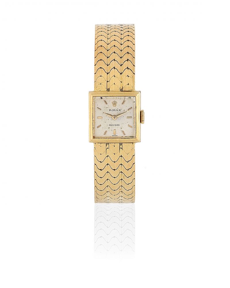 Rolex. A lady's 18K gold manual wind square form bracelet watch