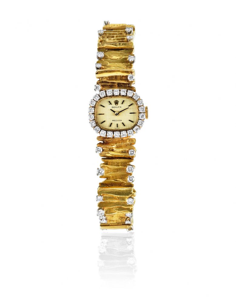 Rolex. A lady's 18K gold and diamond set manual wind bracelet watch