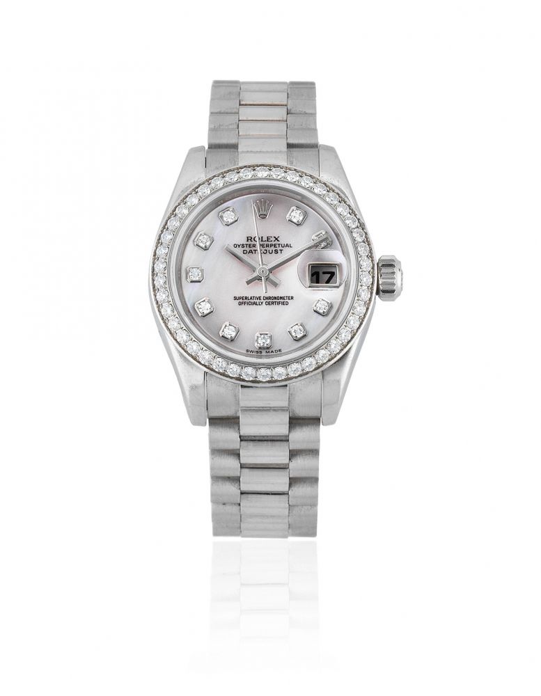 Rolex. A lady's platinum and diamond set automatic calendar bracelet watch with mother of pearl dial
