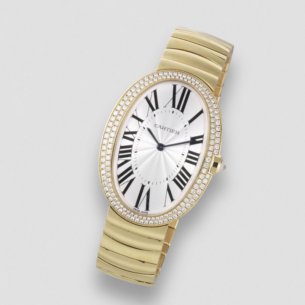 Cartier. An 18K gold and diamond set manual wind oval bracelet watch