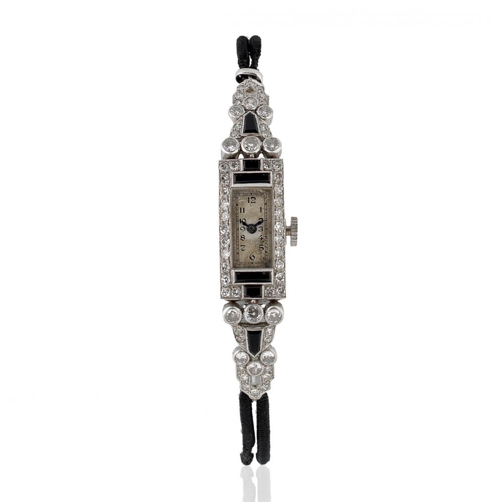 A lady's platinum diamond and onyx set manual wind rectangular cocktail wristwatch