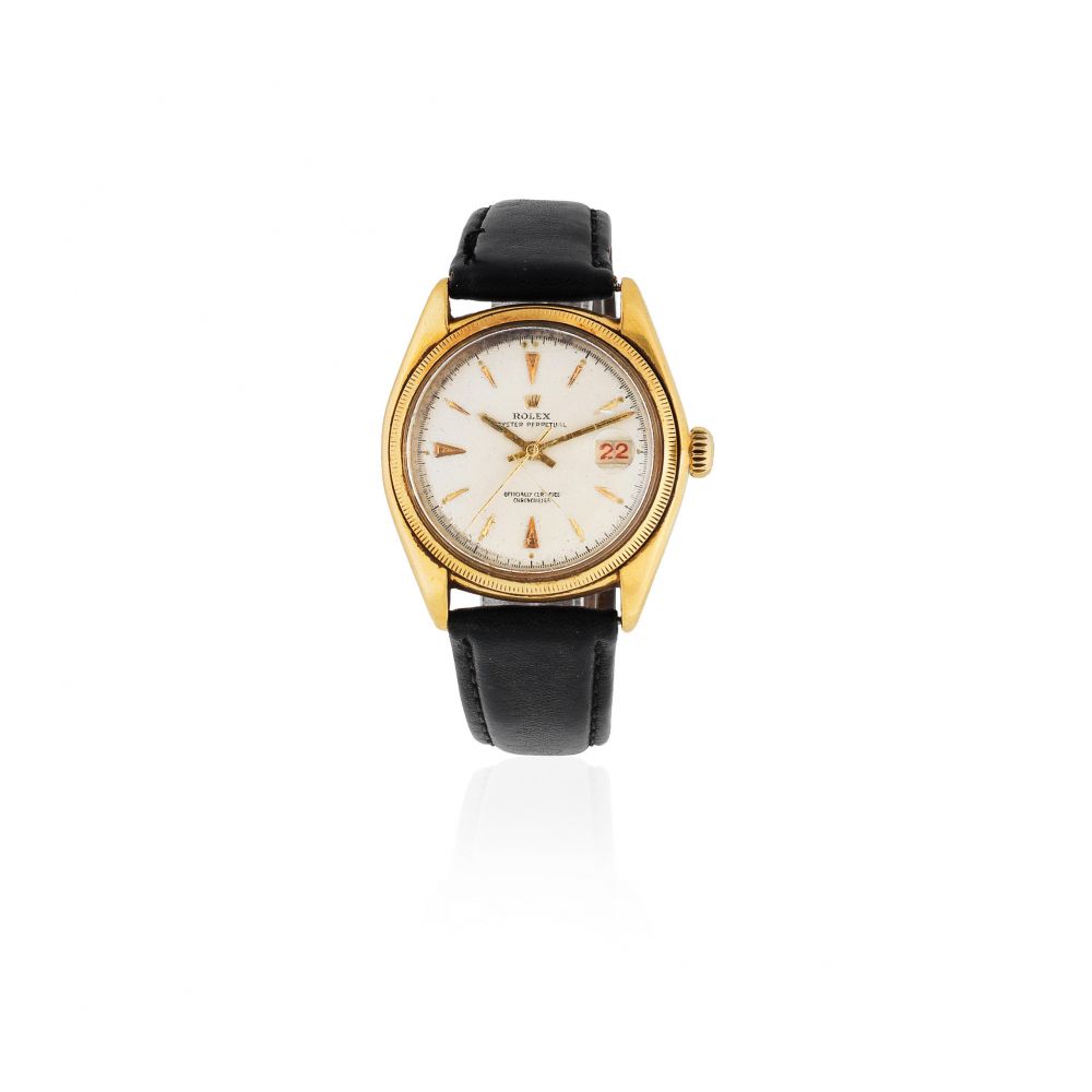 Rolex. An 18K gold automatic calendar bubble back wristwatch with roulette date wheel