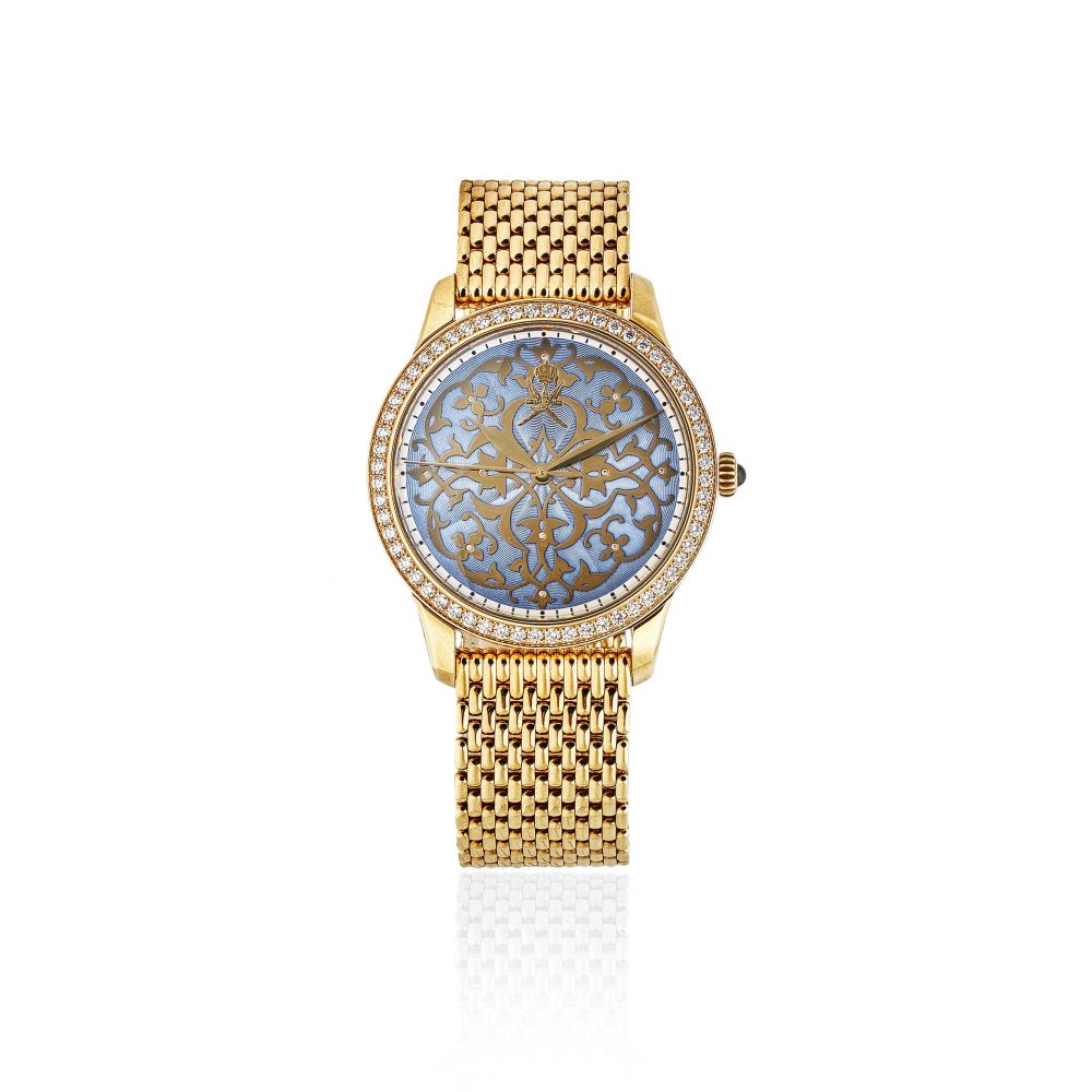 William Son. An unusual 18K gold and diamond set automatic bracelet watch with Khanjar emblem and enamel dial