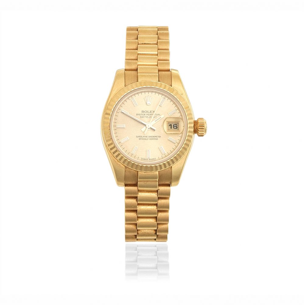 Rolex. A lady's 18K gold automatic calendar bracelet watch