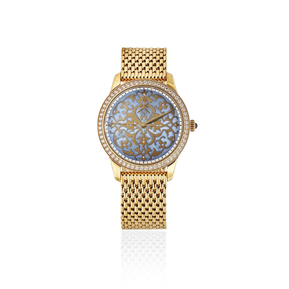 William Son. An unusual 18K gold and diamond set automatic bracelet watch with Khanjar emblem and enamel dial
