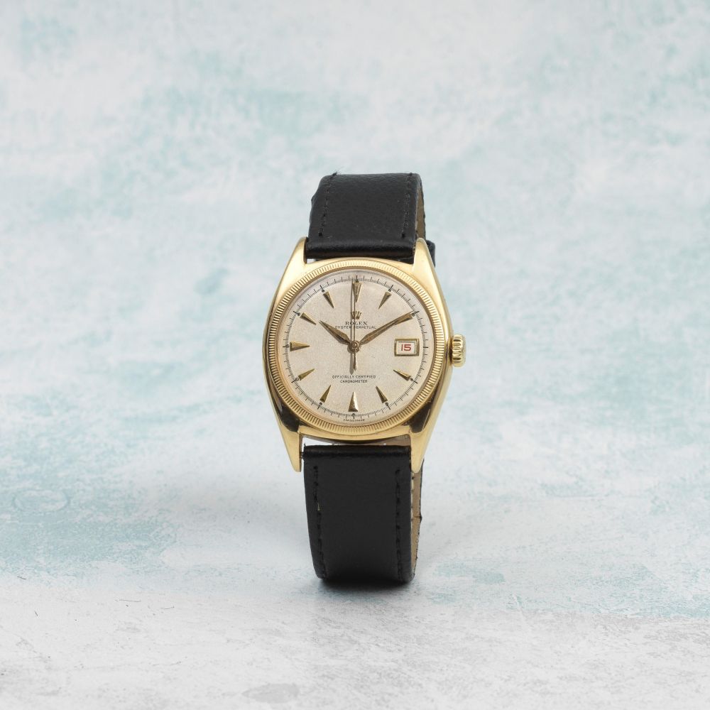 Rolex. An 18K gold automatic bubble back wristwatch with red date and centre seconds