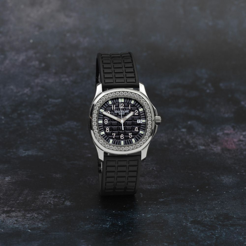 Patek Philippe. A fine stainless steel and diamond set quartz calendar wristwatch