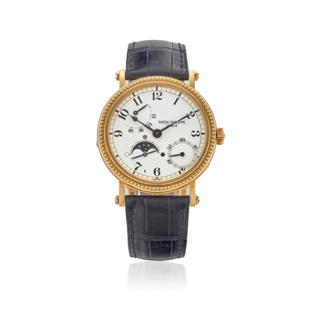 PATEK PHILIPPE. AN 18K GOLD AUTOMATIC WRISTWATCH WITH MOON PHASE AND POWER RESERVE