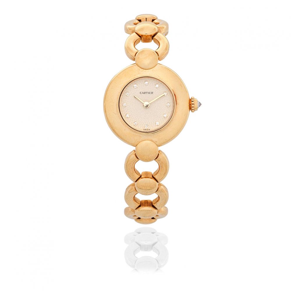 Cartier. A lady's 18K gold quartz diamond set bracelet watch