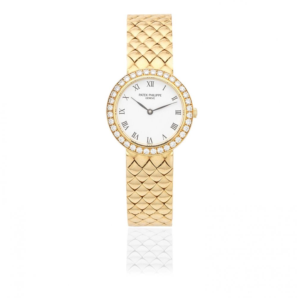 Patek Philippe. A lady's 18K gold diamond set quartz bracelet watch