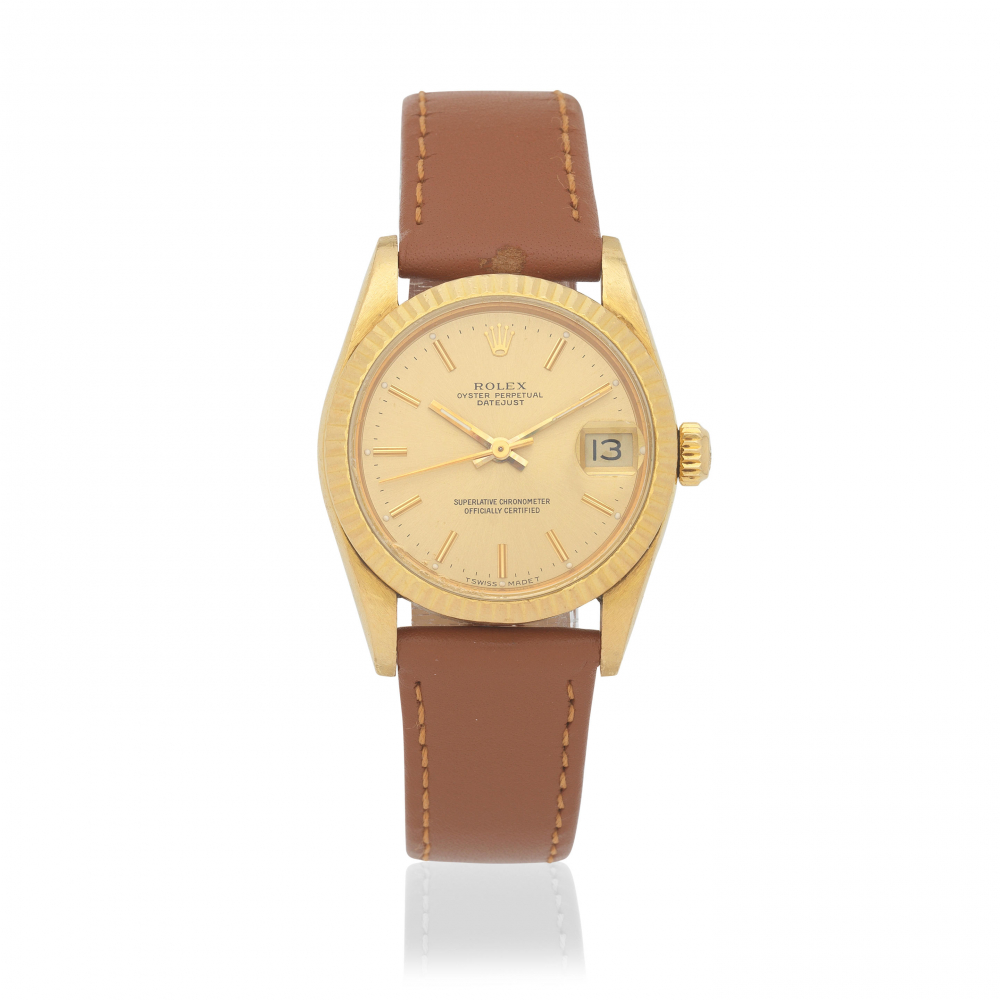 Rolex. A mid-size 18K gold automatic calendar wristwatch