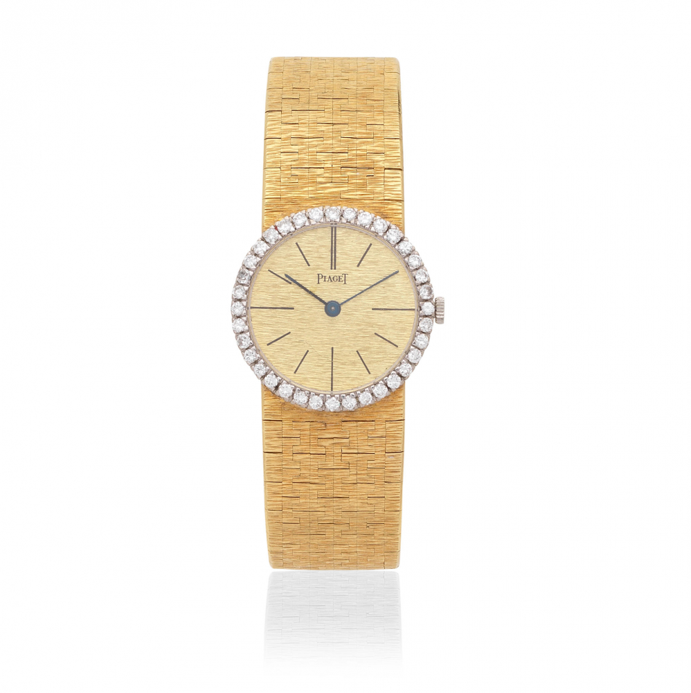 Piaget. A lady's 18K gold diamond set manual wind bracelet watch