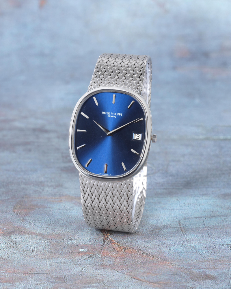 Patek Philippe. An 18K white gold automatic oval calendar bracelet watch with sigma dial