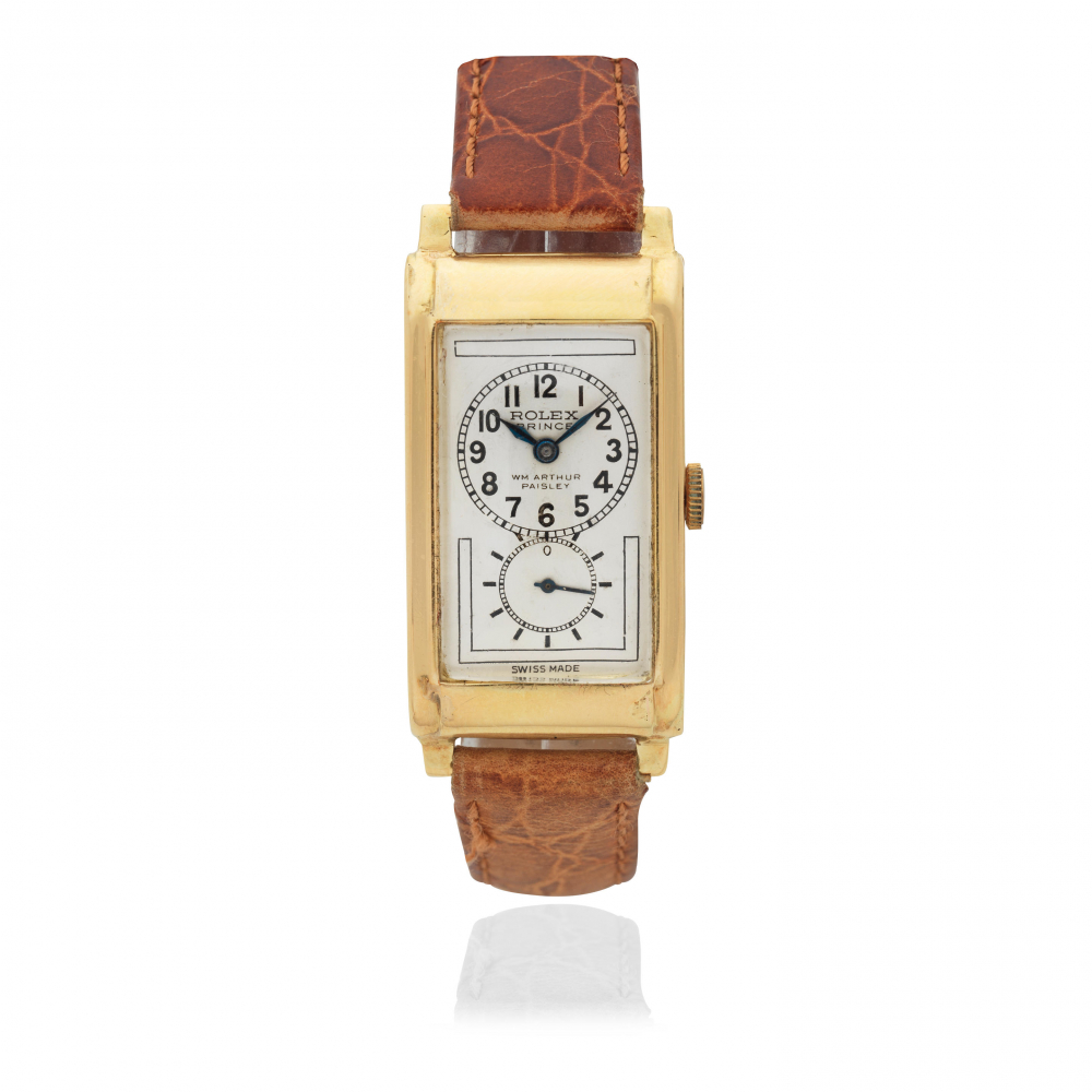 Rolex. An 18K gold manual wind rectangular wristwatch retailed by WM Arthur, Paisley