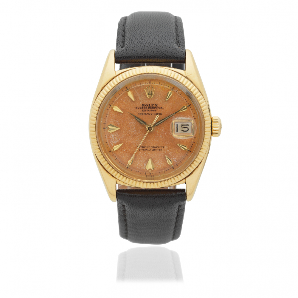 Rolex. An 18K gold automatic calendar wristwatch with roulette date wheel and retailed by Serpico Y Laino