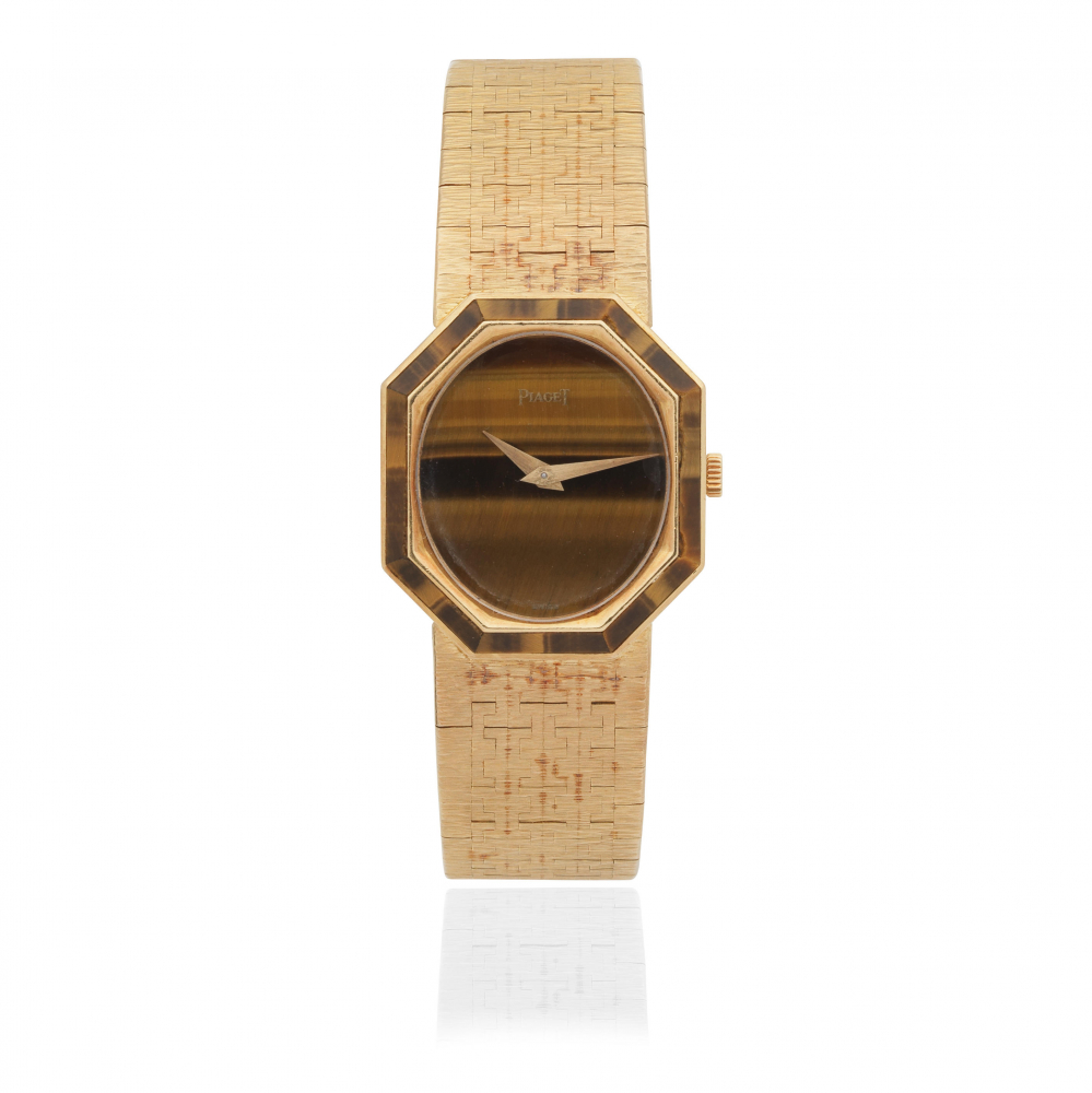 Piaget. A lady's 18K gold manual wind bracelet watch with tigers eye dial and bezel