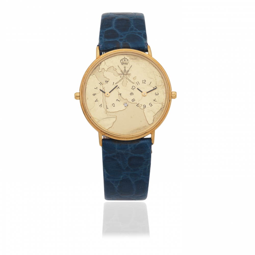 Asprey, London. An 18K gold diamond set quartz dual time wristwatch with Khanjar emblem