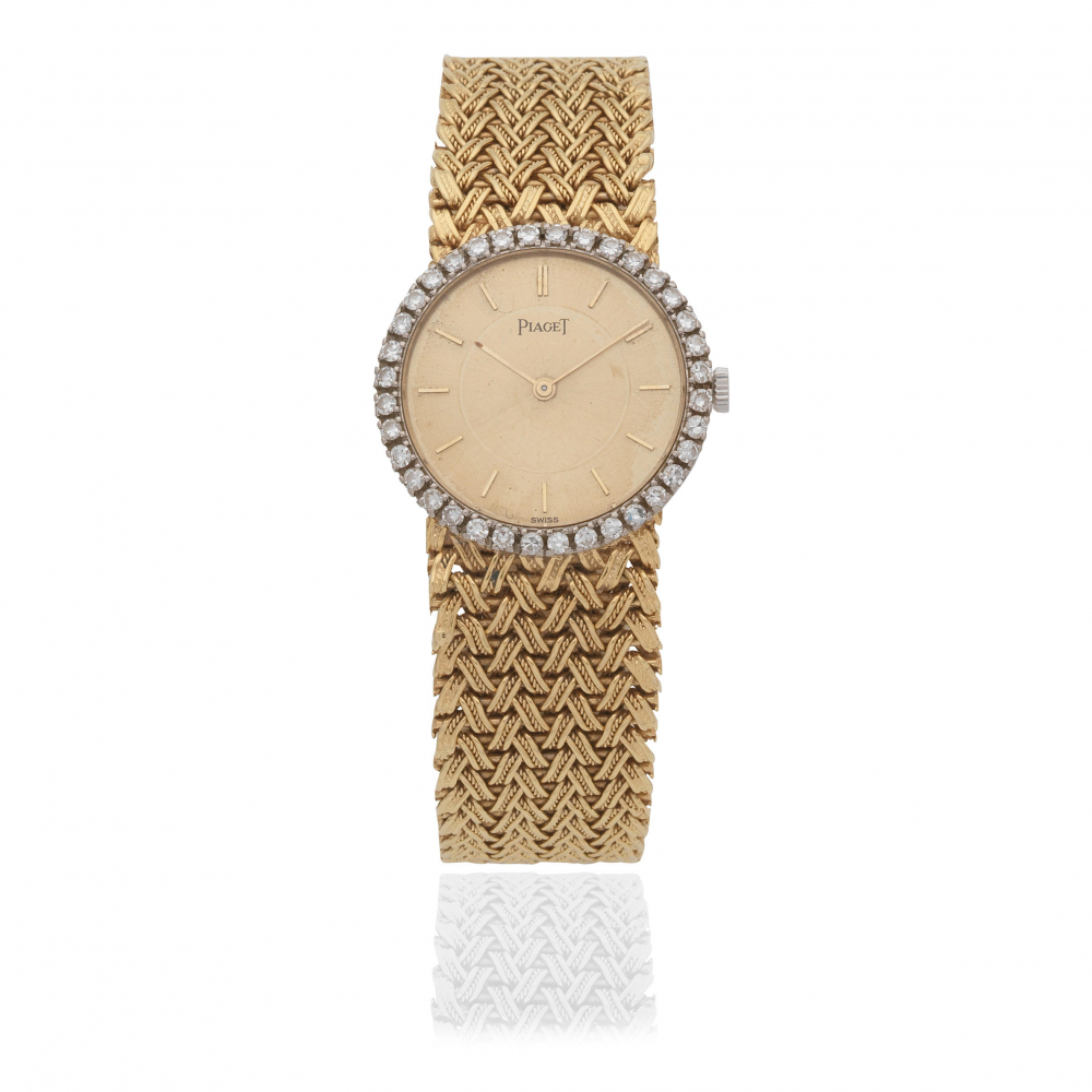 Piaget. A lady's 18K gold and diamond set manual wind bracelet watch