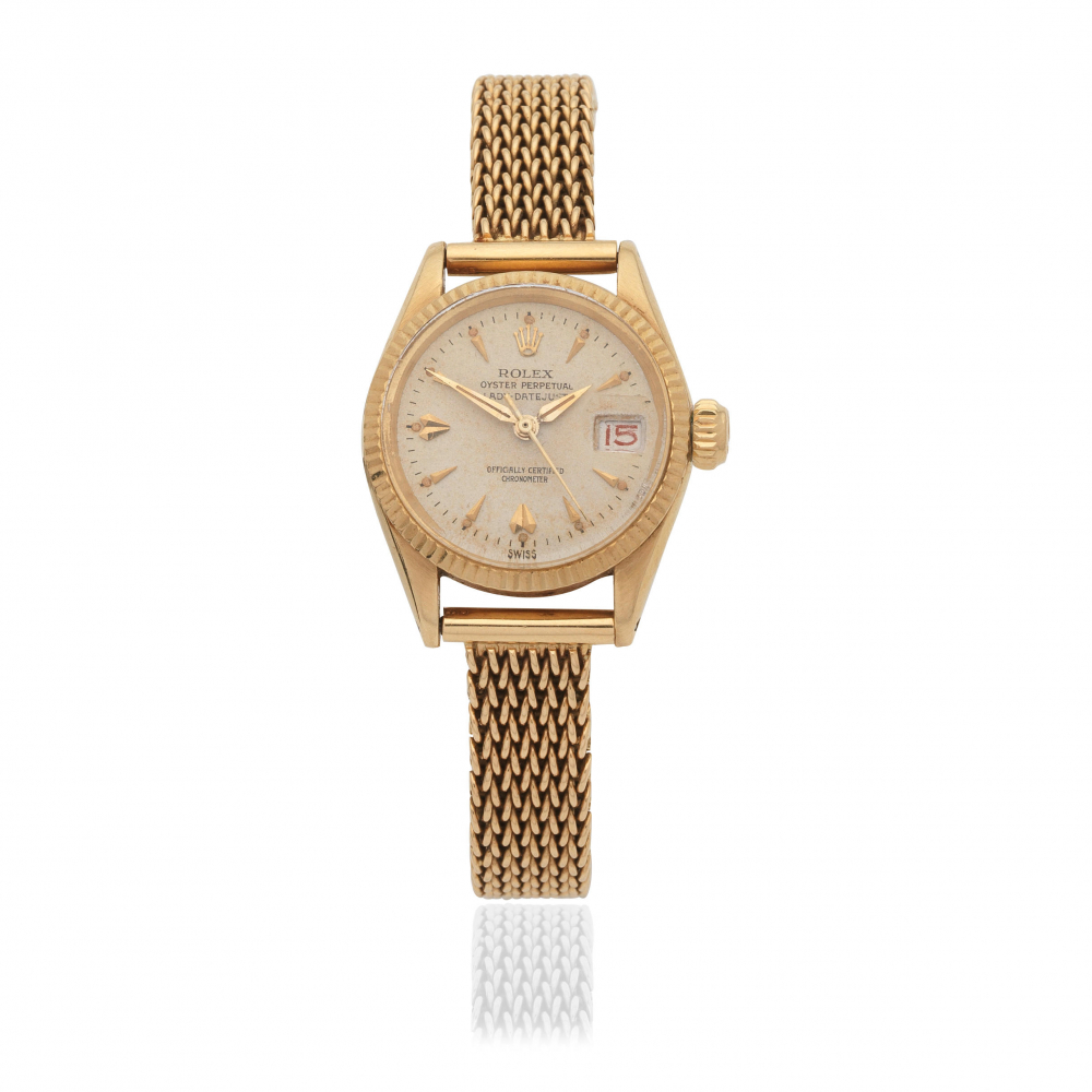 Rolex. A lady's 18K gold automatic calendar bracelet watch