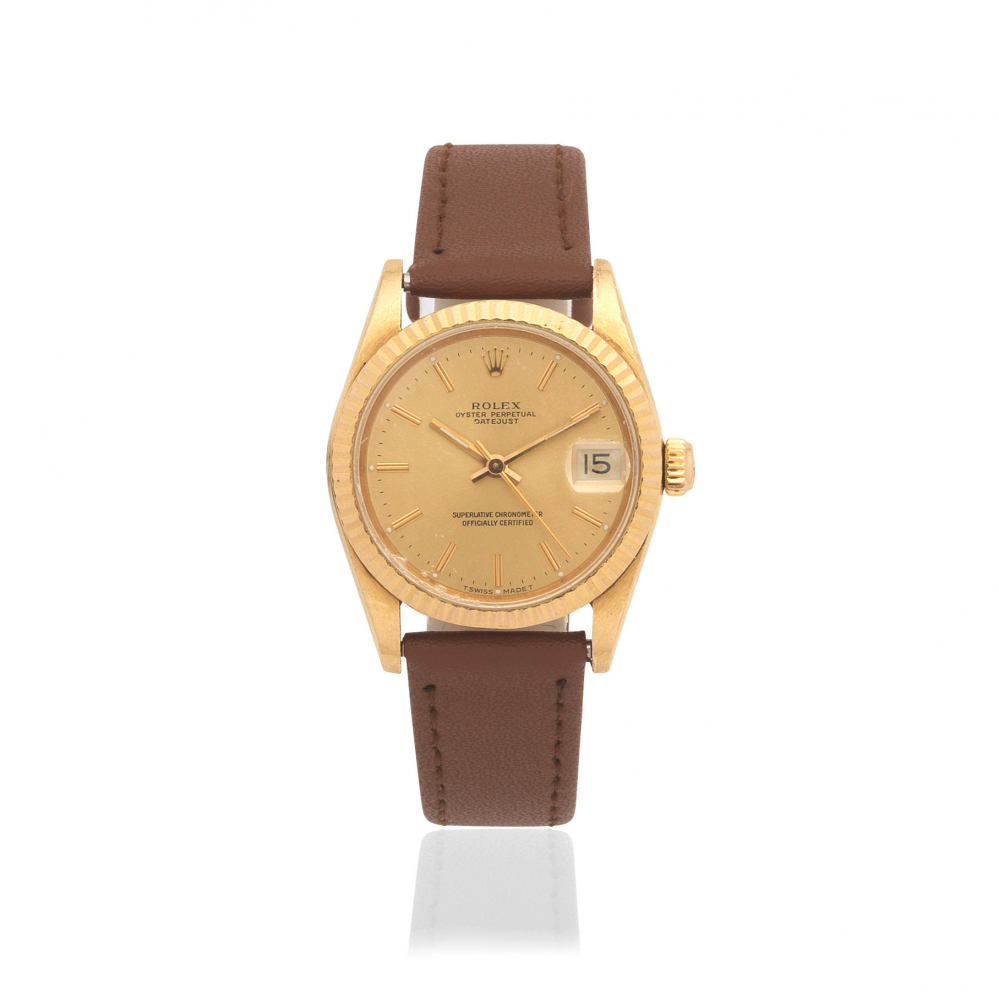 Rolex. A mid-size 18K gold automatic calendar wristwatch