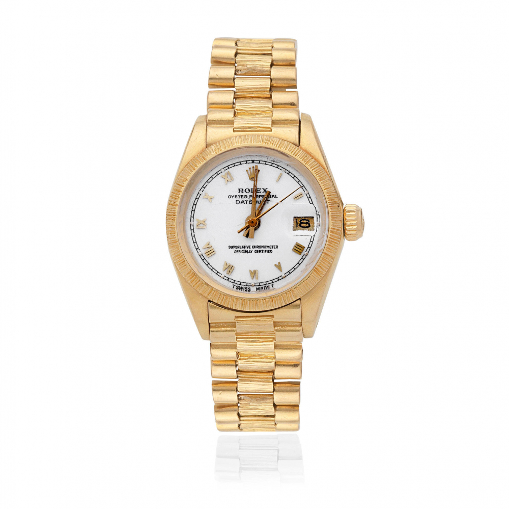Rolex. A lady's 18K gold automatic calendar bracelet watch