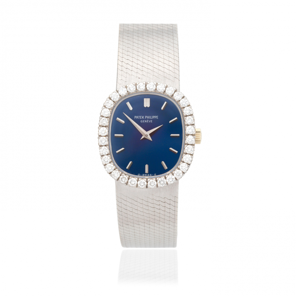 Patek Philippe. A lady's 18K white gold diamond set manual wind bracelet watch with sigma dial