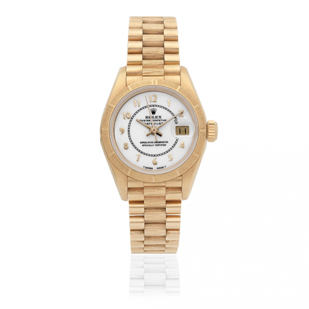 Rolex. A lady's 18K gold automatic calendar bracelet watch