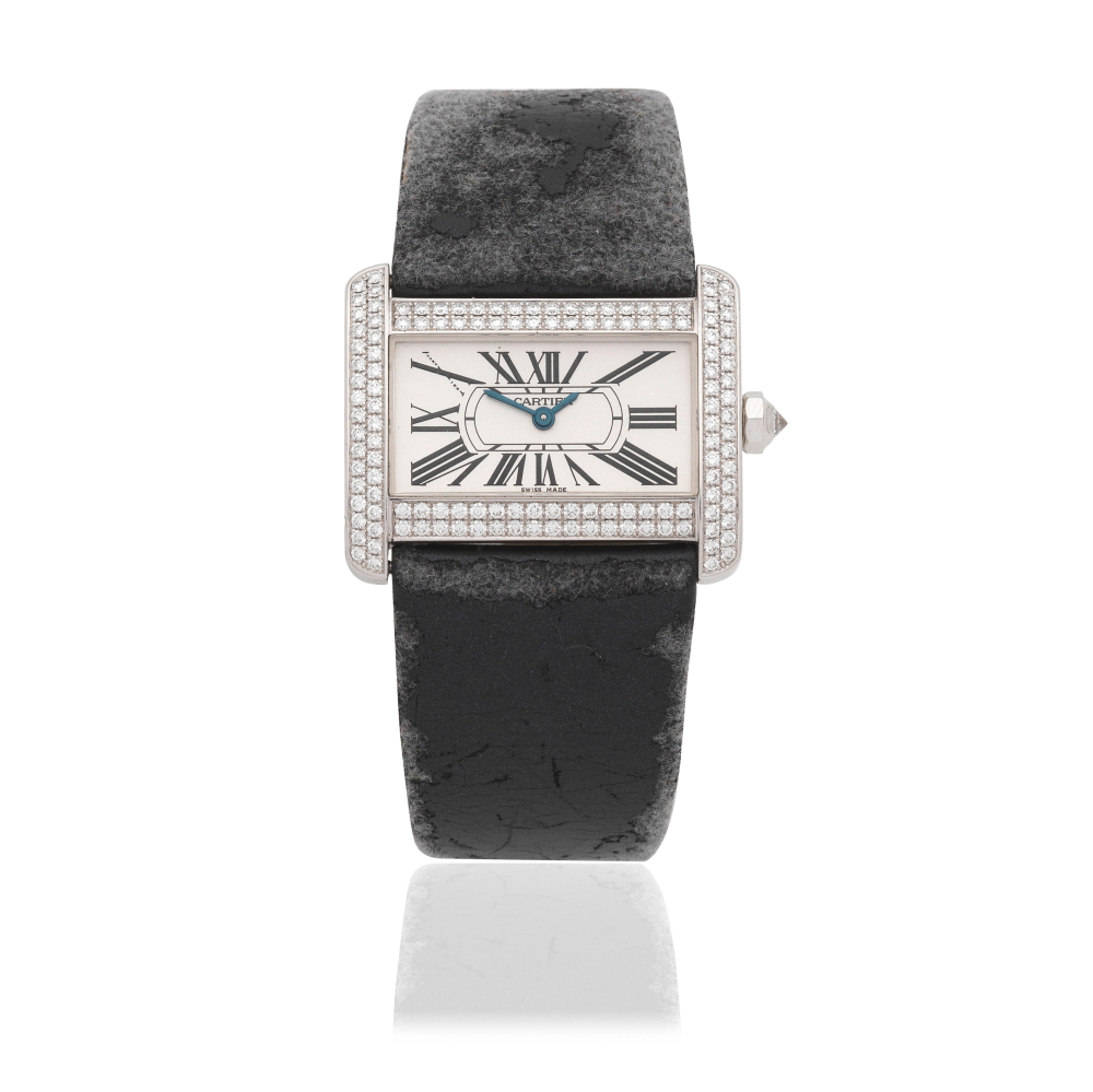 Cartier. A lady's 18K white gold diamond set quartz wristwatch