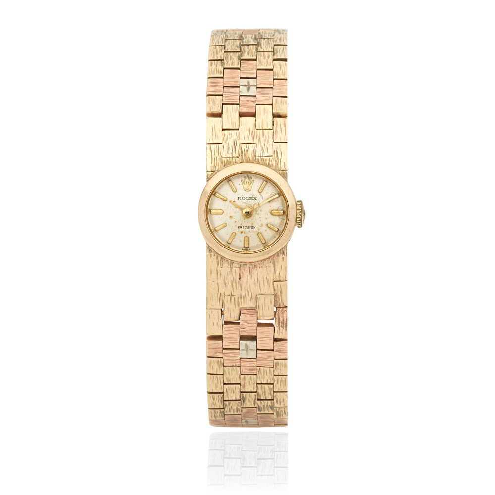 Rolex. A lady's 9K gold manual wind bracelet watch
