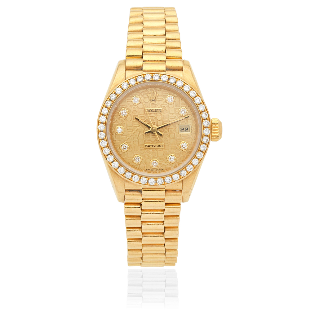 Rolex. A lady's 18K gold diamond set automatic calendar bracelet watch