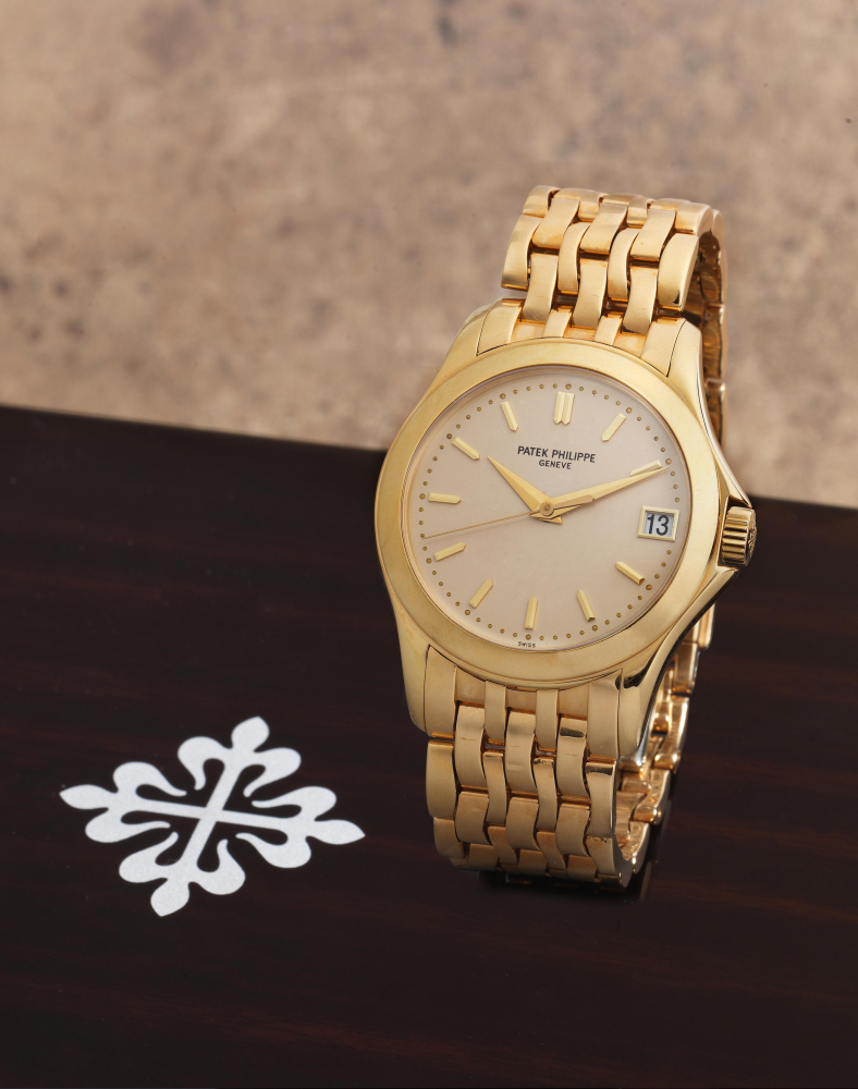 Patek Philippe. A fine 18K gold automatic calendar bracelet watch