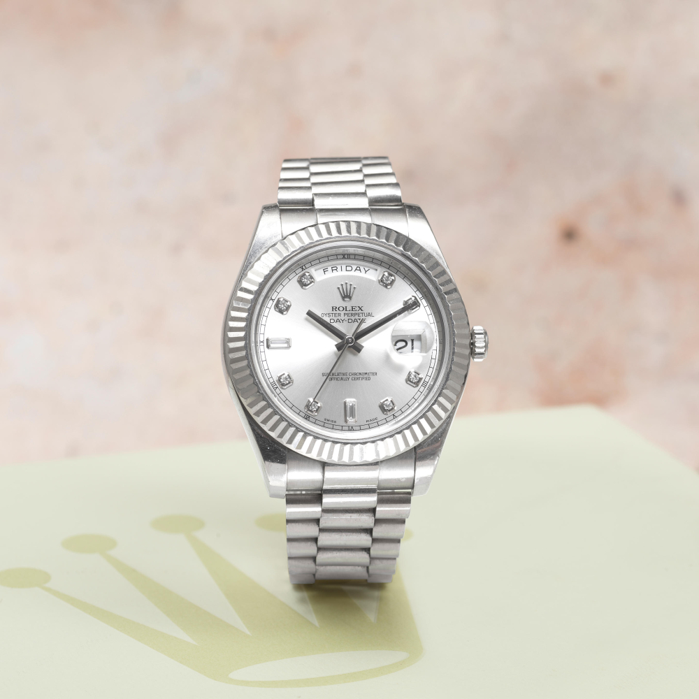 Rolex. A fine 18K white gold diamond set automatic calendar bracelet watch