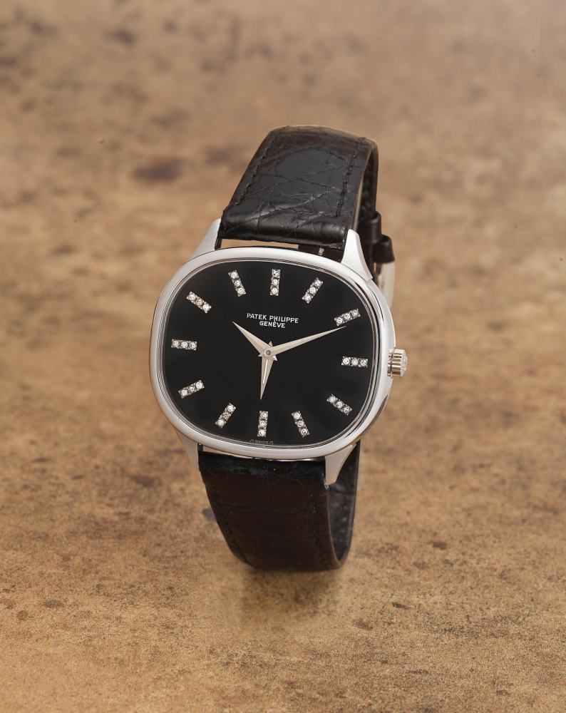 Patek Philippe. A very rare unusual and fine 18K white gold diamond set manual wind wristwatch with dual time zone hand and sigma dial