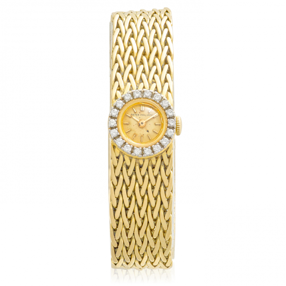 PATEK PHILIPPE. AN 18K GOLD AND DIAMOND BRACELET WATCH