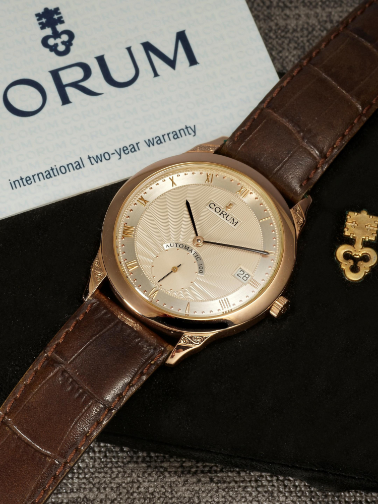 CORUM | ROMULUS, A PINK GOLD WRISTWATCH WITH DATE, CIRCA 2000