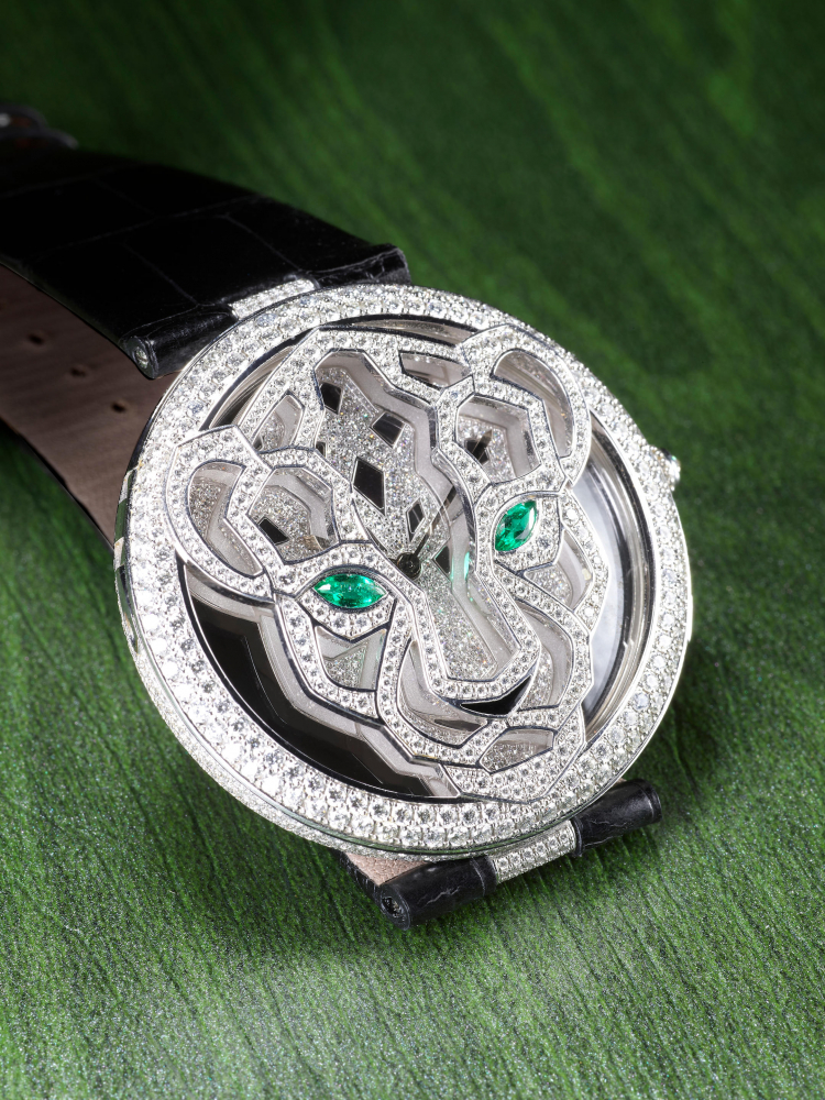 CARTIER | LE CIRQUE ANIMALIER DE CARTIER PANTHER, A RARE LIMITED EDITION WHITE GOLD, DIAMOND AND EMERALD-SET WRISTWATCH WITH OPENWORK CASE OF PANTHER MOTIF AND CONCEALED DIAL, CIRCA 2010