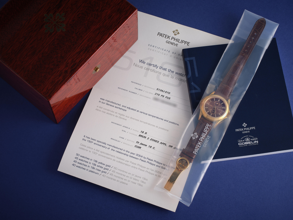 PATEK PHILIPPE | CALATRAVA TRAVEL TIME - GÜBELIN, REF.5134J-010, A RARE LIMITED EDITION SINGLE SEALED YELLOW GOLD DUAL TIME WRISTWATCH WITH DIAL SIGNED BY GÜBELIN, MADE TO COMMEMORATE 150TH ANNIVERSARY OF GÜBELIN, CIRCA 2005
