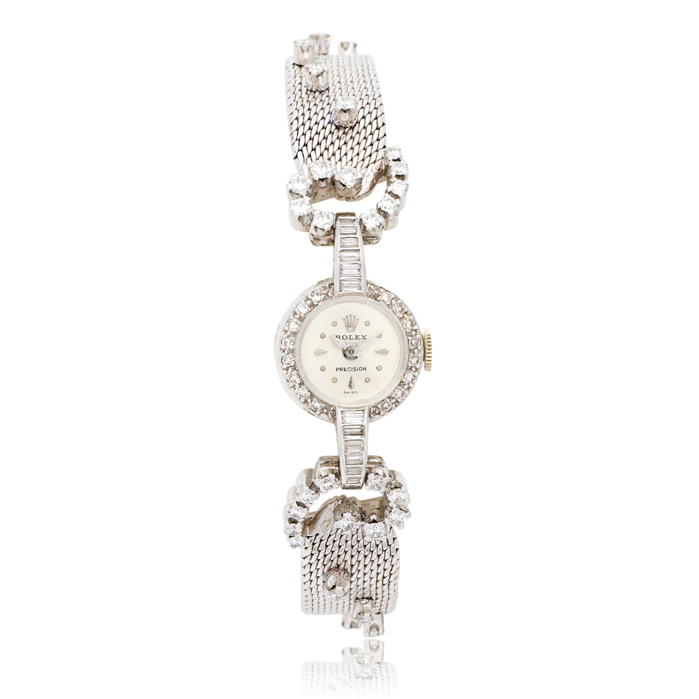 Rolex. A lady's 18K white gold manual wind bracelet watch