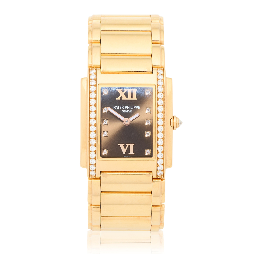 Patek Philippe. A lady's 18K gold diamond set quartz bracelet watch