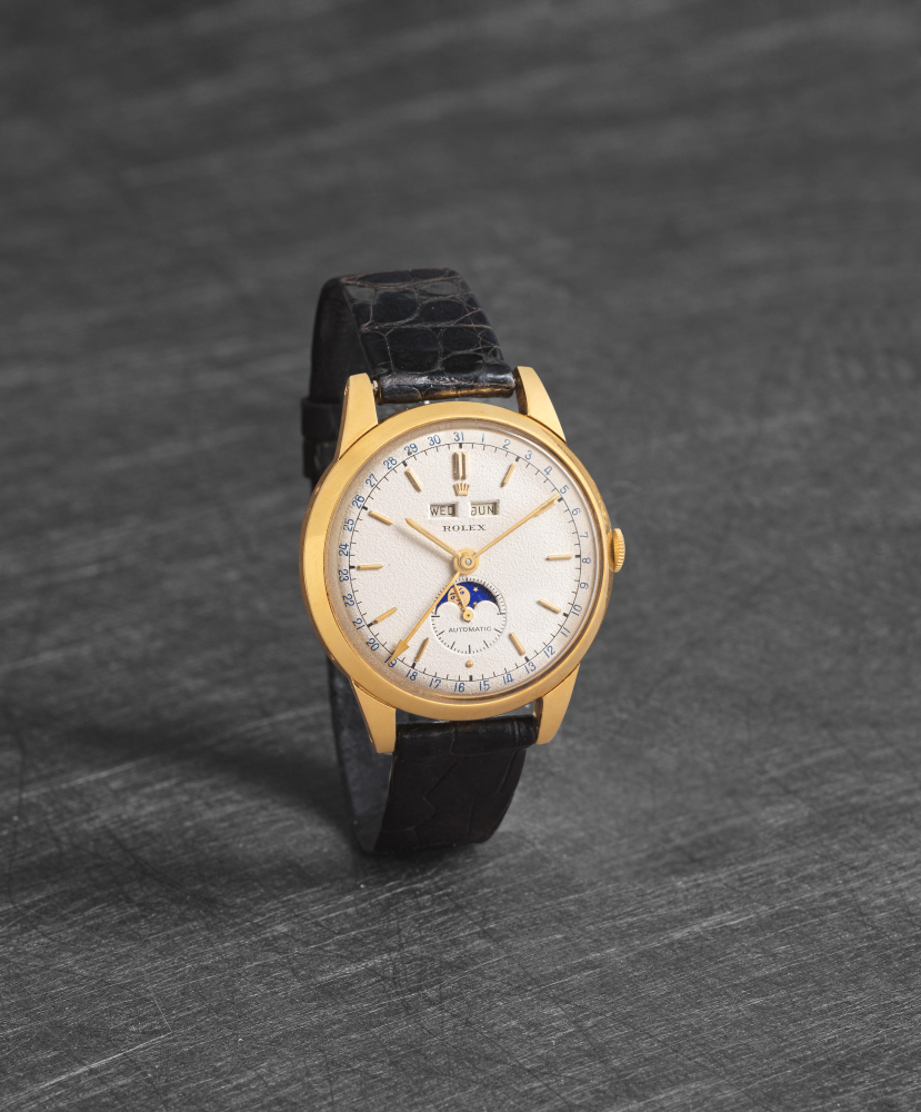 Rolex. A very rare 18K gold automatic triple calendar wristwatch with moon phase