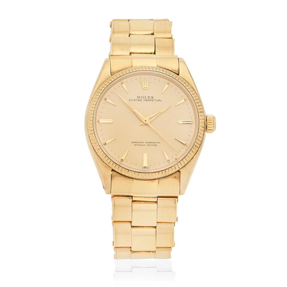 Rolex. A 14K gold automatic wristwatch with 18K gold bracelet