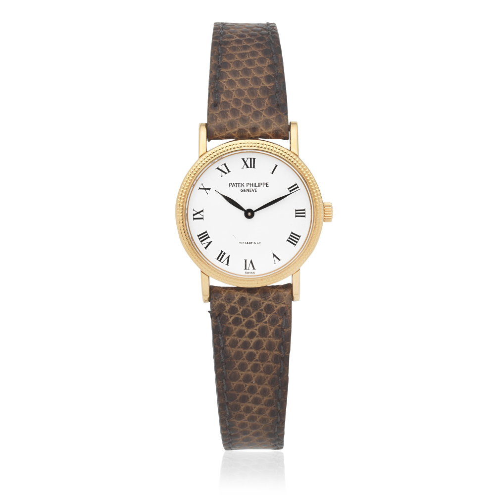 Patek Philippe. A lady's 18K gold manual wind wristwatch Retailed by Tiffany Co