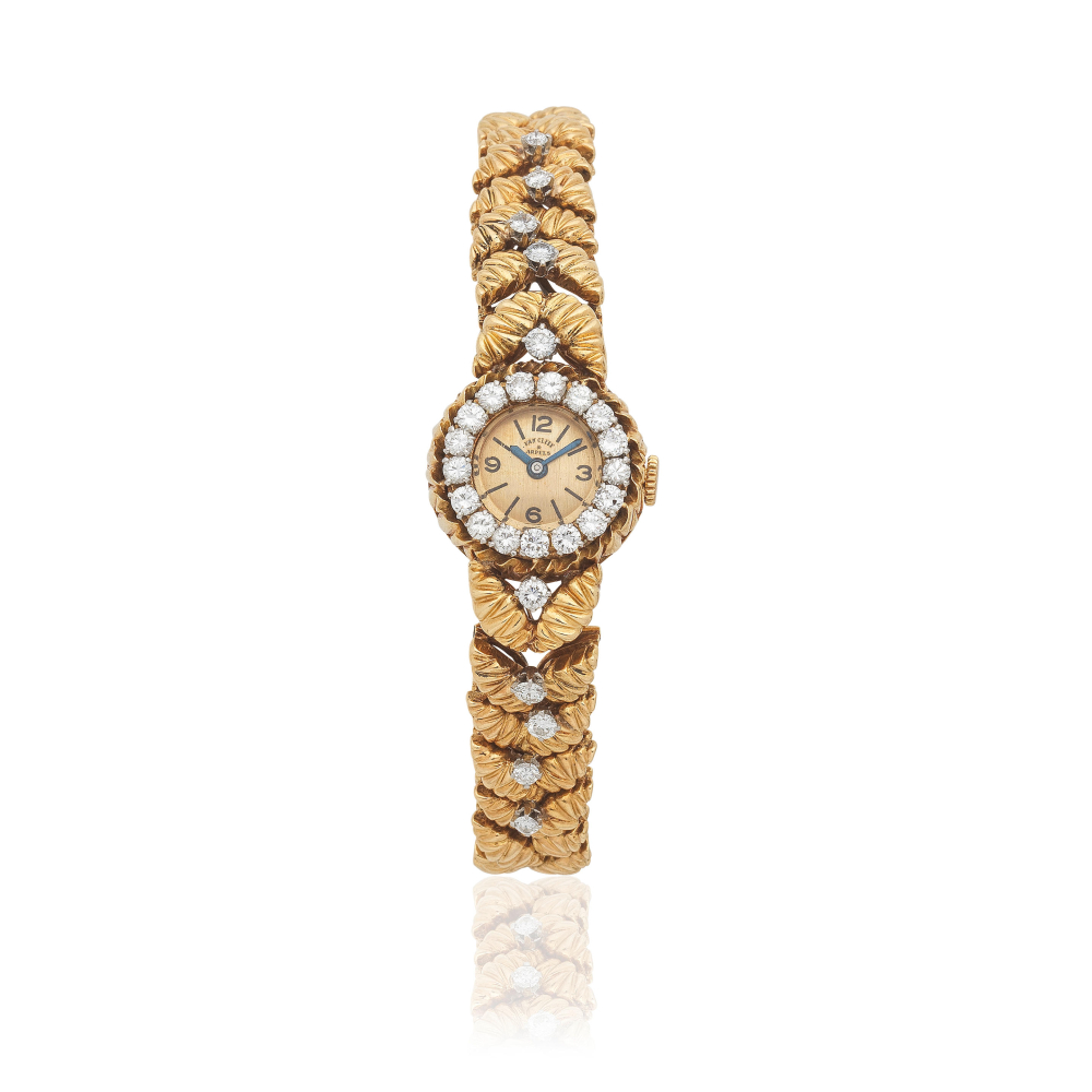 Movado for Van Cleef Arpels. A lady's 18K gold diamond set manual wind bracelet watch