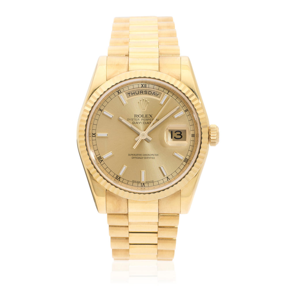 Rolex. An 18K gold automatic calendar bracelet watch